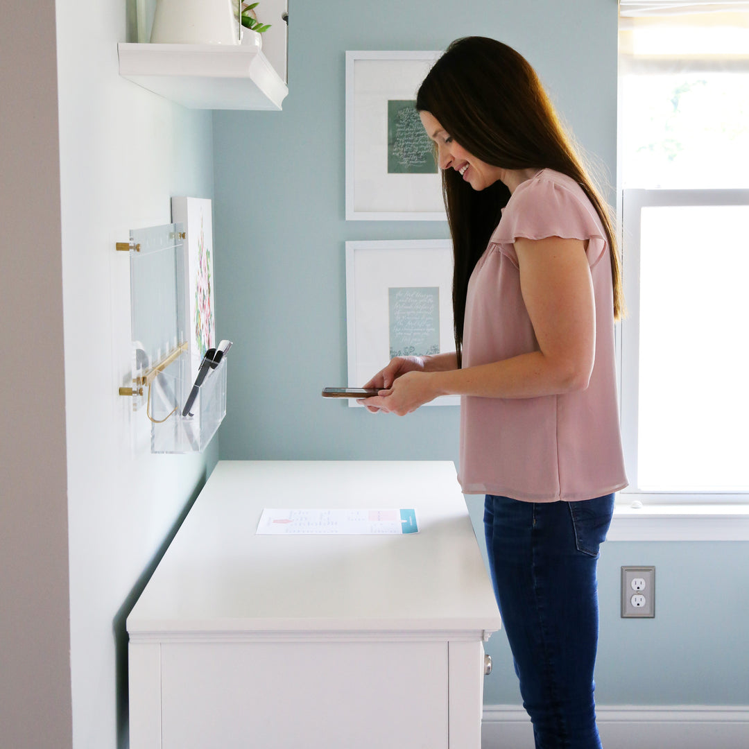 Woman scanning a sheet of paper into Evernote using her smartphone to go paperless