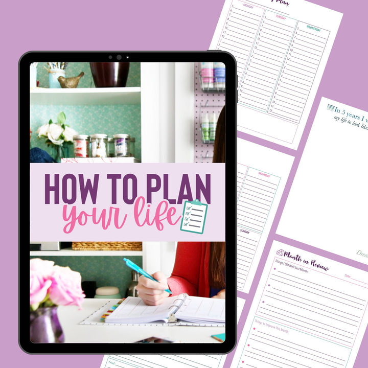An iPad shows "How to Plan Your Life" and a checklist icon, while Abby Organizes Productivity Power Pack Bundle worksheets with stylish prompts are spread on a purple surface beside someone writing in a planner at a desk with flowers.