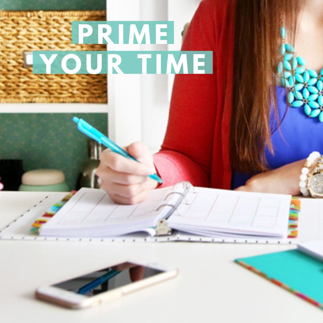 A woman writes in a planner at a desk, with a phone nearby. The text "PRIME YOUR TIME" is overlaid at the top left. The scene suggests organization and productivity.