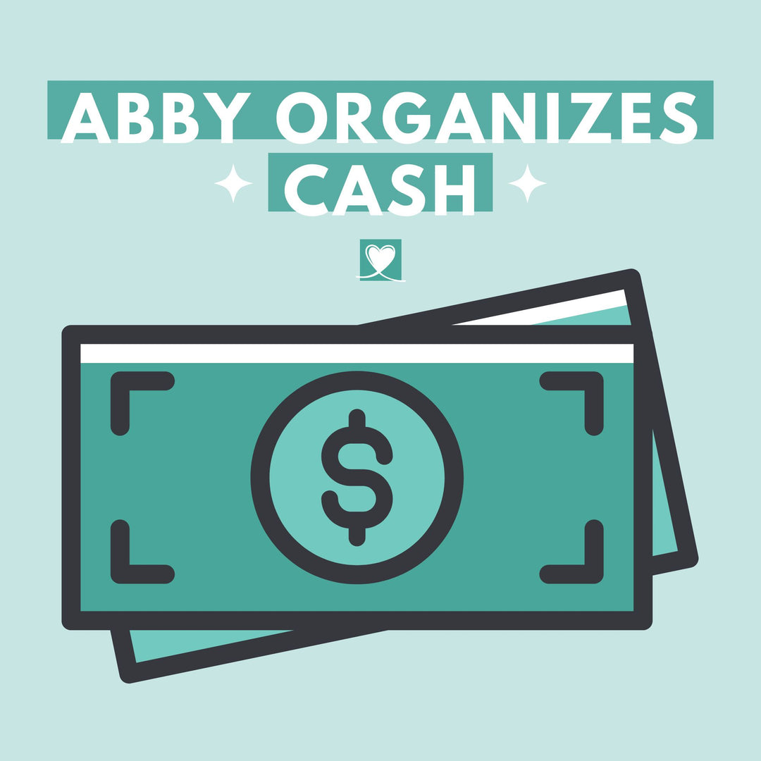 Illustration of two teal dollar bills with a dollar sign under bold "Abby Organizes Cash" text on a light blue background, with a heart icon and the Abby Organizes brand featured at abbyorganizes.com.