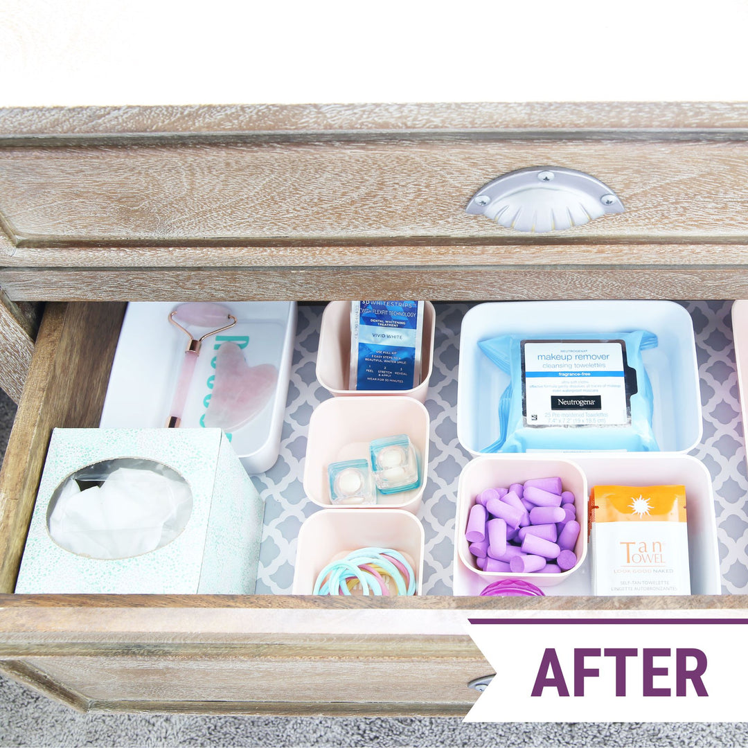Organized nightstand drawer with small bins to divide up the space and a pretty drawer liner